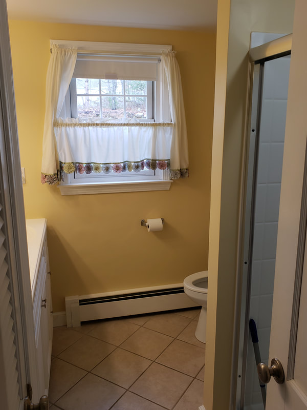 Bathroom remodel with yellow walls and standing shower