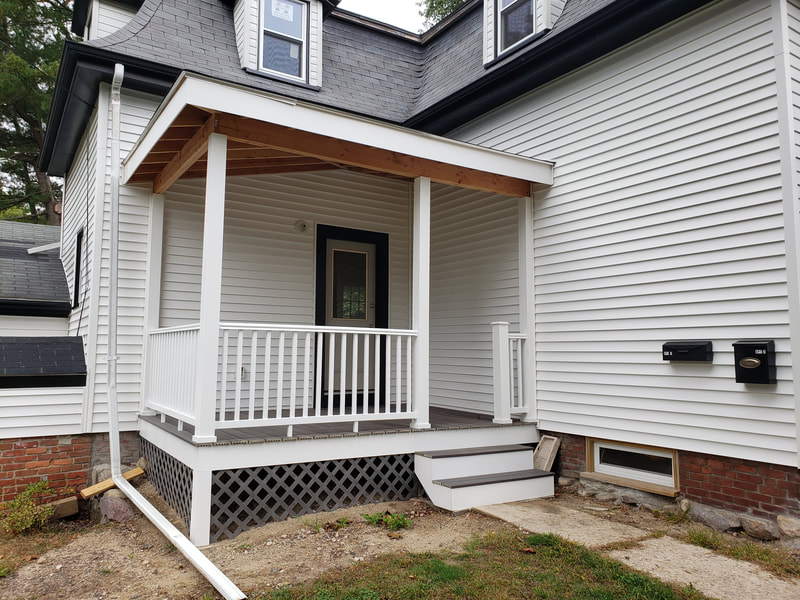 Finished porch construction with siding installed