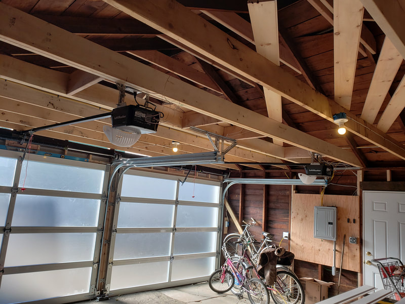 Two door garage remodel with exposed beams inside
